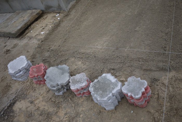Складываем плитку стопками рядом с местом укладки и заодно осматриваем её. Дефектную и кривую плитку лучше отложить в сторону и не использовать.